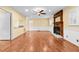 Spacious living room boasts hardwood floors, white trim, ceiling fan, and fireplace at 360 Country Way, Sanford, NC 27332