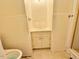 Bathroom with tiled walls, linoleum floors, sink with cabinet, and toilet at 3716 Rivermont Rd, Durham, NC 27712