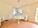 Bright eat-in kitchen features white cabinets and laminate wood flooring at 3716 Rivermont Rd, Durham, NC 27712