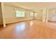 Open-concept living area with laminate floors and large windows at 3716 Rivermont Rd, Durham, NC 27712
