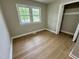 Vacant bedroom featuring hardwood floors and natural light from multiple windows at 3804 Cobb St, Garner, NC 27529