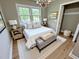 Staged bedroom with large windows, hardwood floors and ample space at 3804 Cobb St, Garner, NC 27529