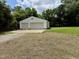 Wide exterior shot of a detached two-car garage with white siding and large yard at 3804 Cobb St, Garner, NC 27529
