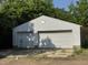 Detached two-car garage with dual doors, white siding, and mature trees in the background at 3804 Cobb St, Garner, NC 27529
