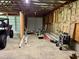 Large unfinished garage space with open rafters and three garage doors at 3804 Cobb St, Garner, NC 27529
