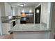 Modern kitchen with white cabinets, granite countertops, and stainless-steel appliances at 3804 Cobb St, Garner, NC 27529