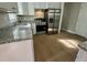 Well-lit kitchen featuring granite counters, stainless steel appliances, and wood flooring at 3804 Cobb St, Garner, NC 27529