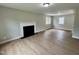 Spacious living room with a fireplace, hardwood floors, and plenty of natural light at 3804 Cobb St, Garner, NC 27529