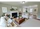 Beautifully staged living room with fireplace, dining area, and hardwood floors at 3804 Cobb St, Garner, NC 27529