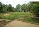 Wood deck overlooking a spacious, overgrown backyard, enclosed by lush trees and greenery at 4109 Stonewall Dr, Raleigh, NC 27604