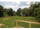 View from the deck overlooks a spacious and lush backyard surrounded by mature trees and landscaping at 4109 Stonewall Dr, Raleigh, NC 27604