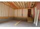 Unfinished basement with exposed insulation, wooden beams, a stairway, and a concrete floor at 4109 Stonewall Dr, Raleigh, NC 27604