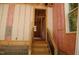 Wooden staircase leading to an unfinished basement, showcasing exposed insulation and framing at 4109 Stonewall Dr, Raleigh, NC 27604