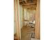 Unfinished bathroom featuring exposed wooden beams, piping, and a partially installed sink at 4109 Stonewall Dr, Raleigh, NC 27604