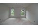 Unfinished bedroom with dual windows offering natural light, ready for customization and personal touches at 4109 Stonewall Dr, Raleigh, NC 27604