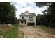 Two-story house with light siding, an attached garage, and a covered entry surrounded by trees at 4109 Stonewall Dr, Raleigh, NC 27604
