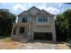 An in-construction, two-story home featuring a two-car garage, light siding, and a covered front porch at 4109 Stonewall Dr, Raleigh, NC 27604