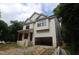 Two-story home with light siding and black trim, featuring an attached garage and covered entry at 4109 Stonewall Dr, Raleigh, NC 27604