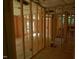 Unfinished interior with wooden framing, insulation, and a staircase visible in the background at 4109 Stonewall Dr, Raleigh, NC 27604