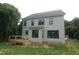 Exterior view of the home's back, featuring a deck and ample windows at 4109 Stonewall Dr, Raleigh, NC 27604