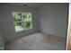 A blank canvas awaits in this unfinished room, with a large window that gives outdoor views at 4109 Stonewall Dr, Raleigh, NC 27604