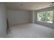 Spacious room featuring rough subfloor and a large window letting in natural light at 4109 Stonewall Dr, Raleigh, NC 27604