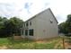 New construction home featuring light-colored siding, trimmed windows, and a partially wooded lot at 4109 Stonewall Dr, Raleigh, NC 27604