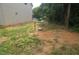 A spacious side yard with a newly constructed home, showing the landscape and utilities at 4109 Stonewall Dr, Raleigh, NC 27604