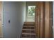 Unfinished staircase with exposed framing and window letting in natural light at 4109 Stonewall Dr, Raleigh, NC 27604