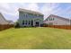 Spacious backyard with green lawn, patio set, and privacy fence at 42 Village Walk Dr, Chapel Hill, NC 27517