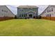 Large backyard with a well-manicured lawn and patio seating at 42 Village Walk Dr, Chapel Hill, NC 27517
