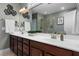 Bright bathroom featuring double sink vanity with wood cabinets and a glass enclosed shower at 42 Village Walk Dr, Chapel Hill, NC 27517