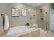 Spa bathroom features a soaking tub with tile surround and glass enclosed shower, offering a relaxing space at 42 Village Walk Dr, Chapel Hill, NC 27517