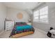Bright bedroom with neutral walls, carpet, and large windows with a decorative wicker accent at 42 Village Walk Dr, Chapel Hill, NC 27517