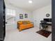 Bedroom featuring a futon, a desk and chair, a closet, and a large window at 42 Village Walk Dr, Chapel Hill, NC 27517