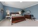 Bright blue bedroom features plush carpet, large windows and wood furniture, offering a serene and inviting space at 42 Village Walk Dr, Chapel Hill, NC 27517