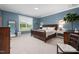 Blue bedroom features wood furniture, large windows and a plush carpet, offering a serene and inviting space at 42 Village Walk Dr, Chapel Hill, NC 27517