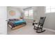 Bright bedroom features neutral walls, carpet, a rocking chair and large windows at 42 Village Walk Dr, Chapel Hill, NC 27517