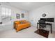 Bedroom featuring a futon, a desk and chair, a closet, and a large window at 42 Village Walk Dr, Chapel Hill, NC 27517