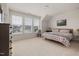 Bright bedroom features neutral carpet, large windows, and colorful bedding, offering a cozy and inviting space at 42 Village Walk Dr, Chapel Hill, NC 27517