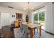 Bright dining room with a wooden table, hardwood floors, and backyard views at 42 Village Walk Dr, Chapel Hill, NC 27517