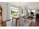 Dining room with wooden table, chairs, and a sliding glass door to the backyard at 42 Village Walk Dr, Chapel Hill, NC 27517