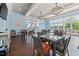 Well lit dining area with large windows, dark wood floors, and modern chandeliers at 42 Village Walk Dr, Chapel Hill, NC 27517