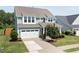 Attractive two-story home with a well-kept lawn, attached garage, and a welcoming front porch at 42 Village Walk Dr, Chapel Hill, NC 27517