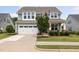 Charming two-story home features a well-manicured lawn and a two-car garage at 42 Village Walk Dr, Chapel Hill, NC 27517