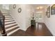 Elegant foyer features hardwood floors, staircase, and a welcoming entrance with ample natural light at 42 Village Walk Dr, Chapel Hill, NC 27517