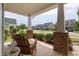 Charming front porch features brick pillars, lush greenery, and cozy rocking chairs, perfect for relaxing at 42 Village Walk Dr, Chapel Hill, NC 27517