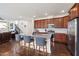 Open kitchen area featuring a center island with barstool seating and stainless appliances at 42 Village Walk Dr, Chapel Hill, NC 27517