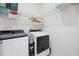 Laundry room features modern side-by-side washer and dryer units with wire shelving storage at 42 Village Walk Dr, Chapel Hill, NC 27517