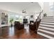 Inviting living room with hardwood floors, fireplace, and staircase access at 42 Village Walk Dr, Chapel Hill, NC 27517